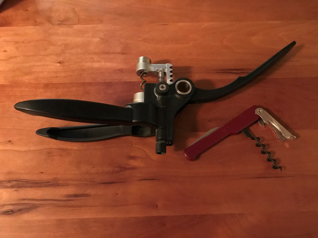 Two common corkscrews: a rack-and-pinion mechanism (black) and a four-bar linkage (red).